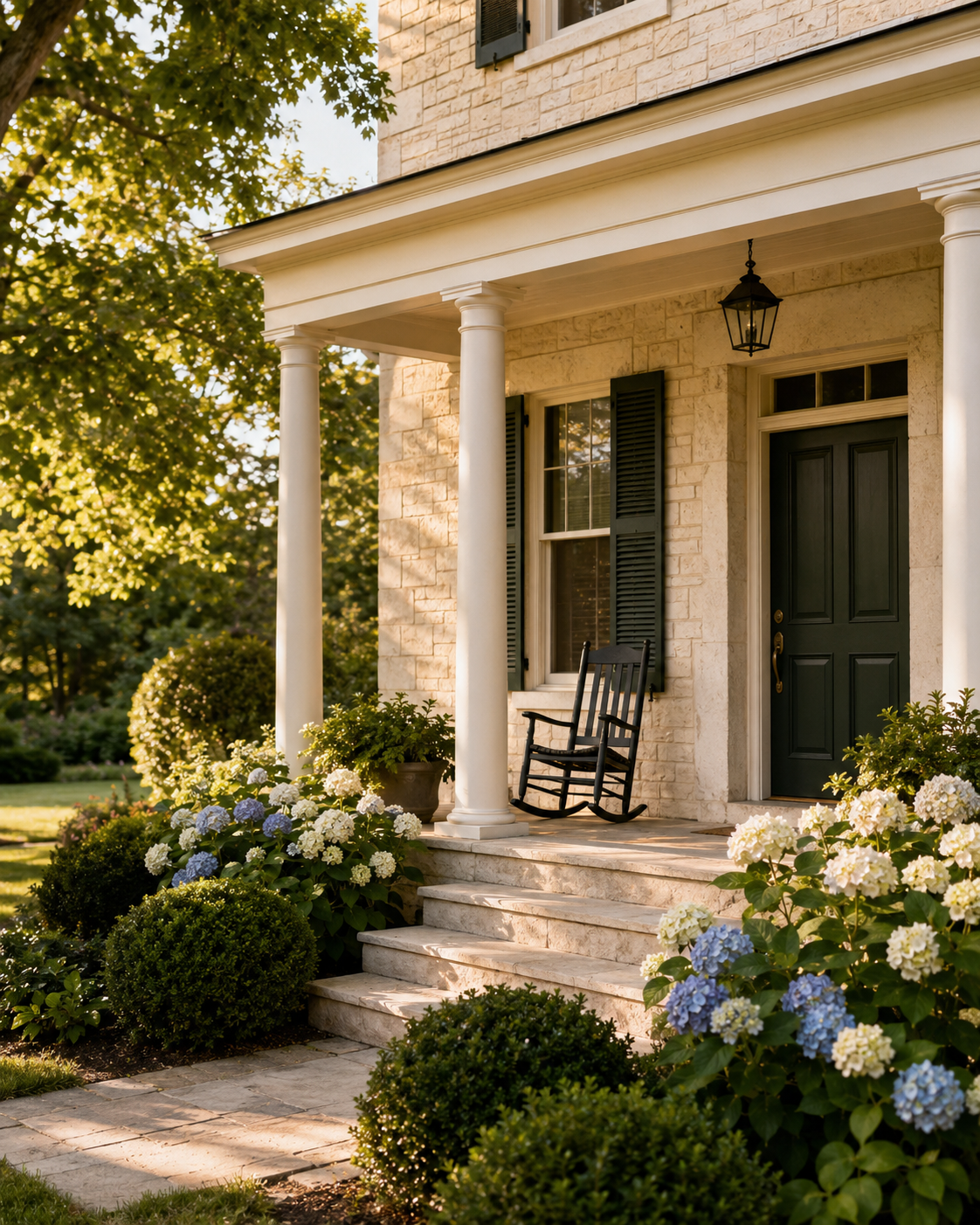 A welcoming front porch with a dark green door, rocking chair, and landscaping